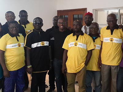 Bankole Cardoso, managing director of Easy Taxi flanked by members of staff and benefitting taxi drivers pose for photography during Easy Taxi appreciation of the drivers' loyalty in Lagos.