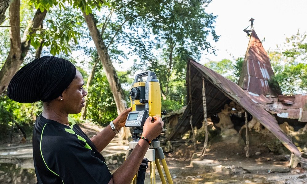 Dr. Ijeoma adjusts the total station at Busanyin shrine